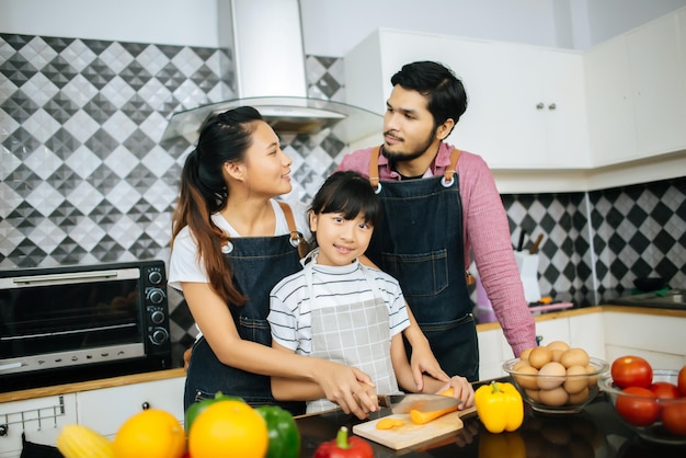 Family preparing food in kitchen at home