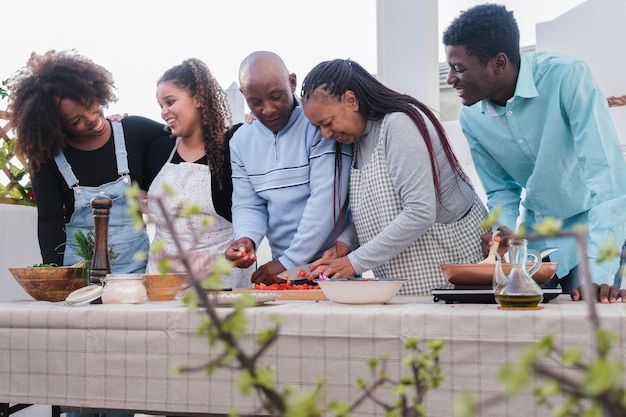 Family preparing a healthy meal to share together on the terrace and enjoy dinner Concept healthy food family outdoors