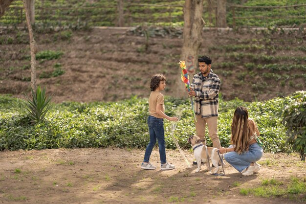 Family preparing a kite to fly in a park