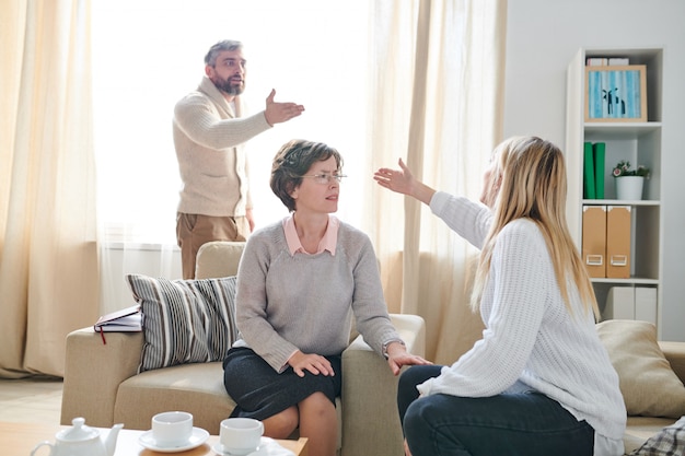 Family psychologist listening to quarrel of couple