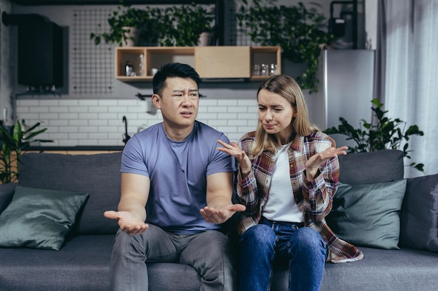 family quarrel woman complains about husband online consultation with a psychologist multiracial couple sitting on sofa at home