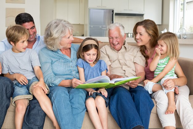 Family reading storybook in living room