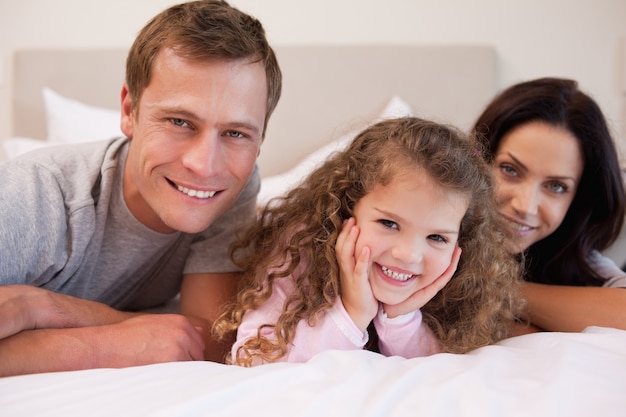 Family relaxing in the bedroom together