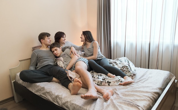 Family Relaxing Together In Bedu Happy family concept
