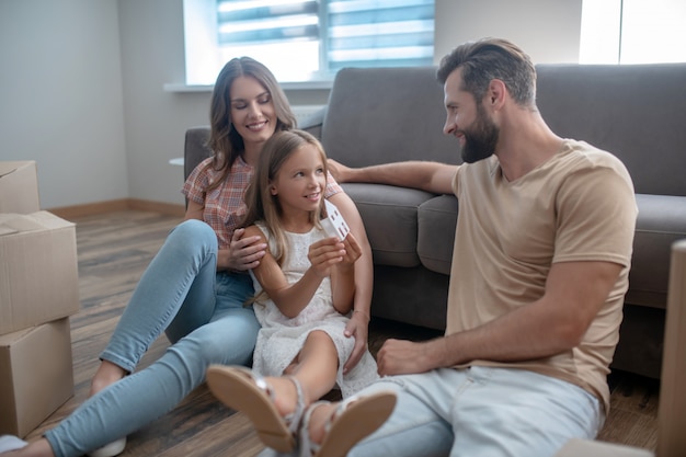 Family resting on the floor after moving