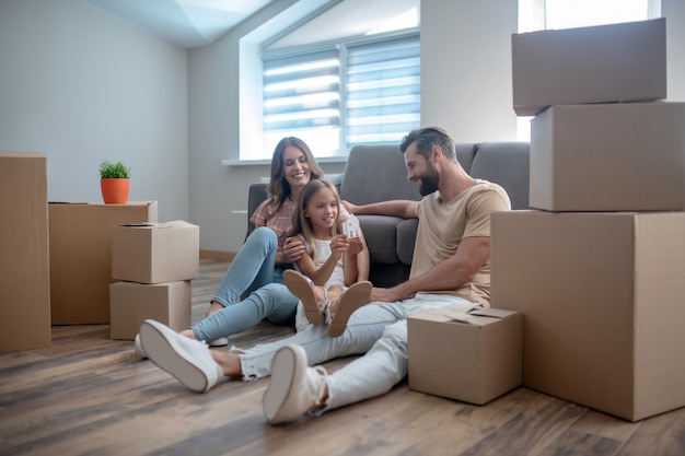 Family resting on the floor after moving