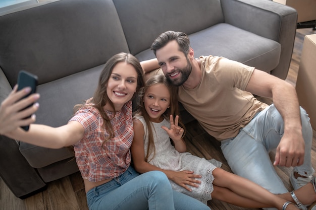 Family resting on the floor after moving