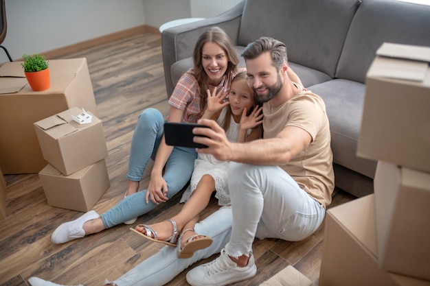 Family resting on the floor after moving