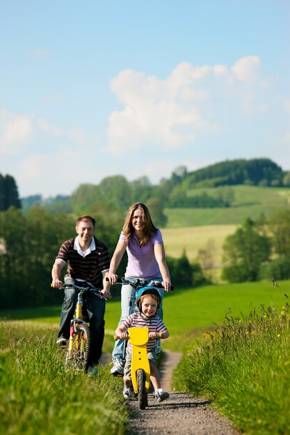 Family riding bicycles in summer