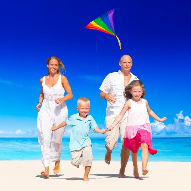 Family running on the beach.