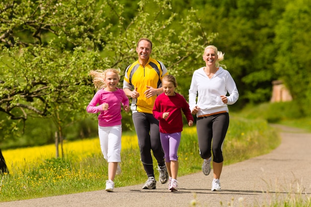 Family running in the meadow for sport