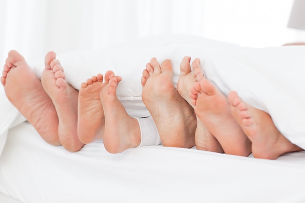 Family's feet in the bed