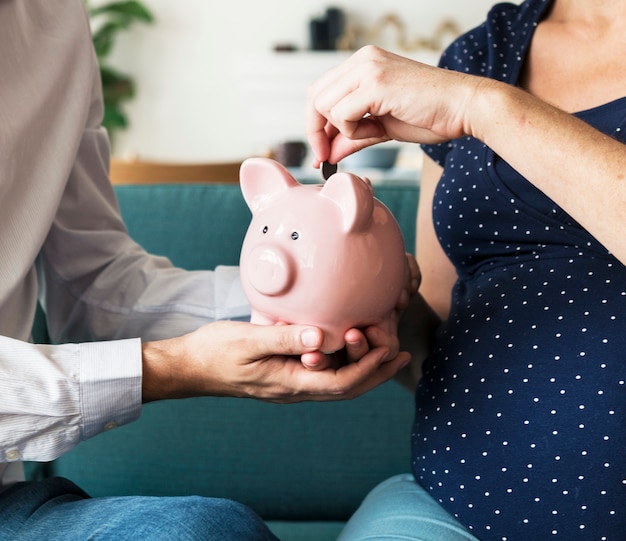 Family saving money in piggy bank