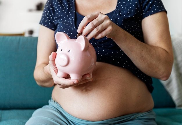 Family saving money in piggy bank