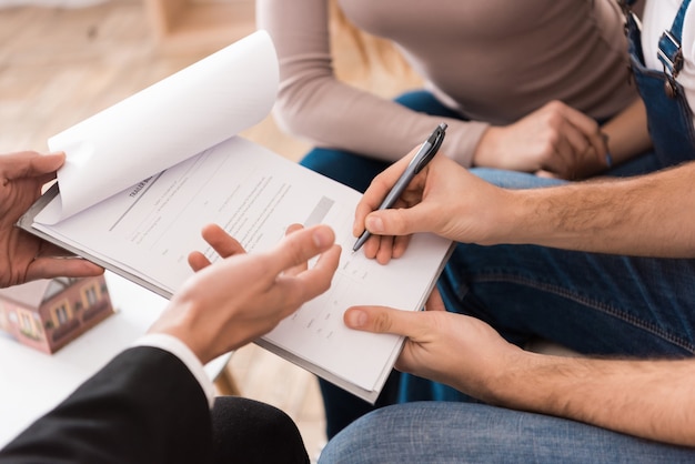 Family signs associate agreement to buy house