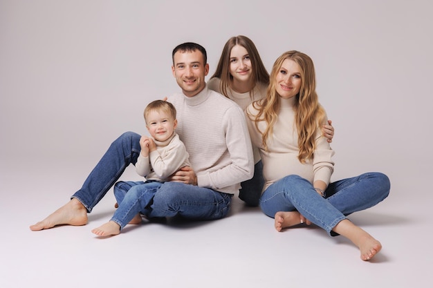 Photo a family sits on the floor in a studio.