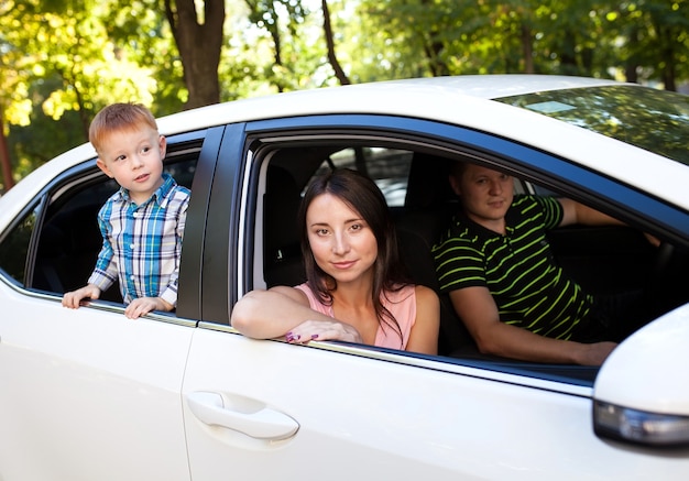 Famiglia seduta in macchina a guardare fuori dalle finestre