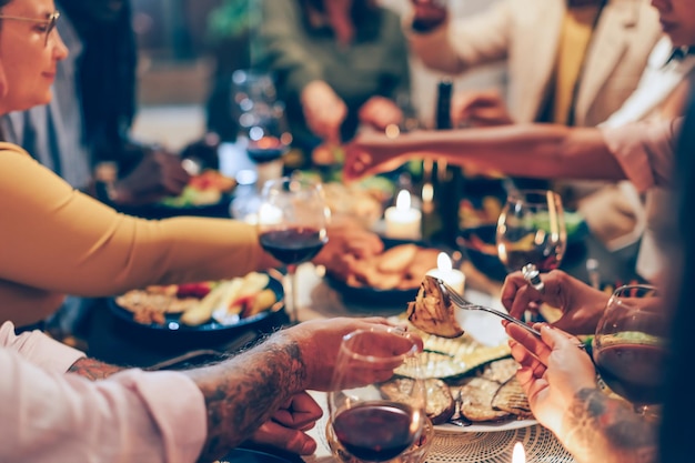 Family sitting at the table vegan friends having dinner
together fucus in the foreground