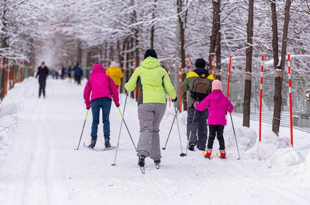 Family skiing at public park during an amazing winter day