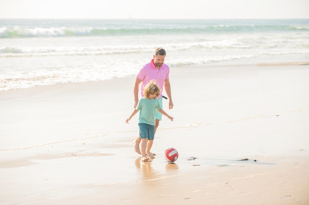 Family of smiling daddy man and child boy playing ball on beach
best friends