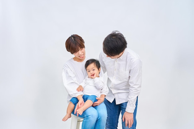 Family smiling and lining up in front of white background