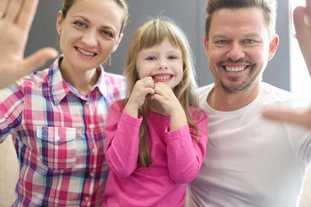 Family smiling portrait of mom dad and daughter