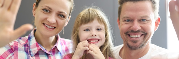 Family smiling portrait of mom dad and daughter