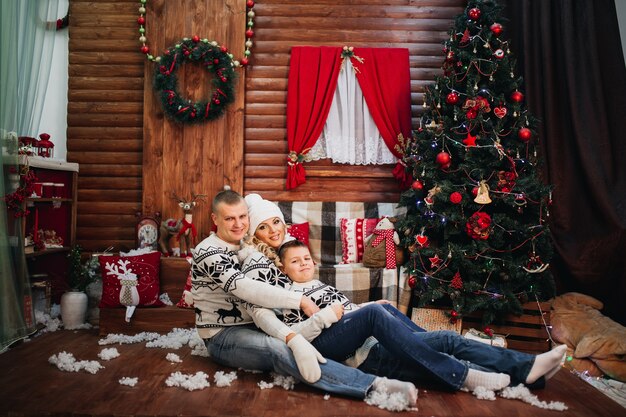 Family and son hug in matching sweaters