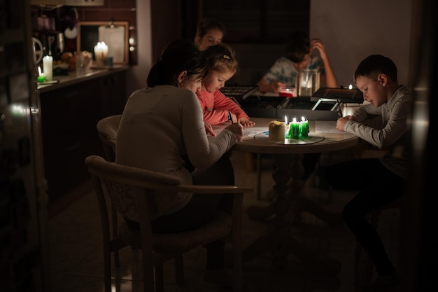 Family spending time together during an energy crisis in Europe causing blackouts Kids drawing in blackout