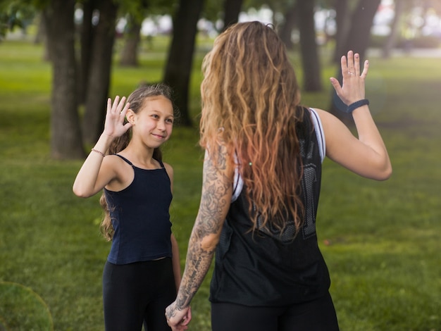 family sport. happy mother and daughter training outdors