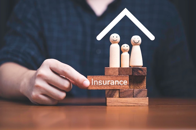 Family standing on wooden block with hand pulling block which print screen insurance on it for assurance life and asset concept