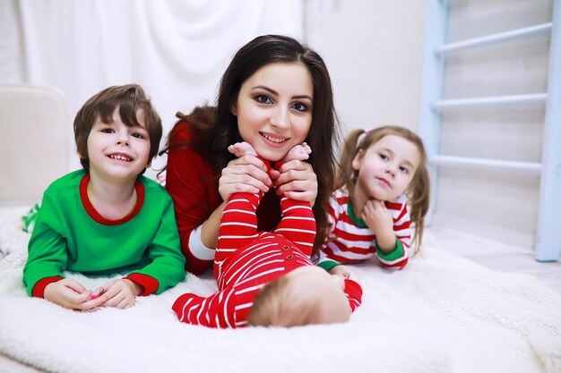 A family in striped pajamas is resting at home A happy family