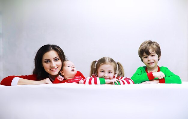 A family in striped pajamas is resting at home A happy family