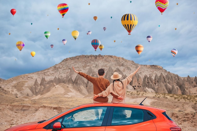 Family summer vacation in Cappodocia with hot air balloons in the background Hot air balloon flights European holiday and car travel concept