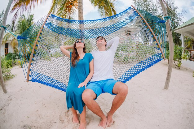 Family on summer vacation relaxing in hammock