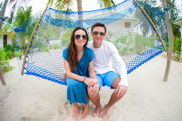 Family on summer vacation relaxing in hammock