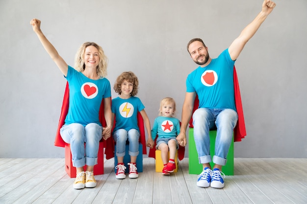 Family of superheroes playing at home