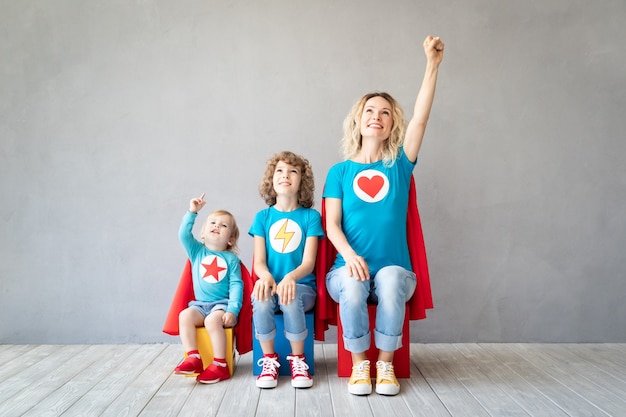 Family of superheroes playing at home