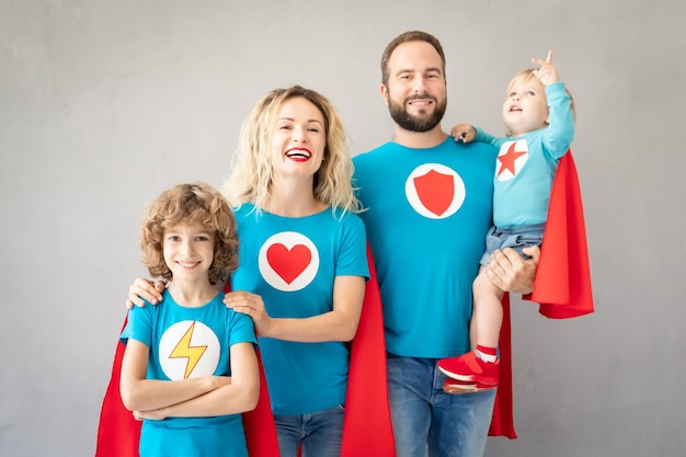 Photo family of superheroes playing at home