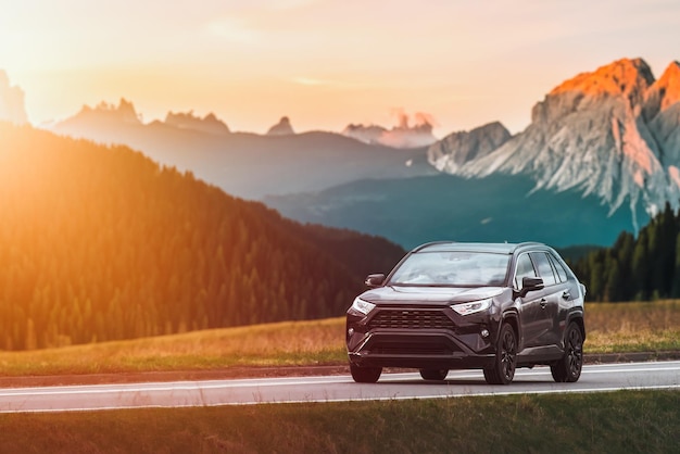 family suv car on scenic road with sunset backdrop