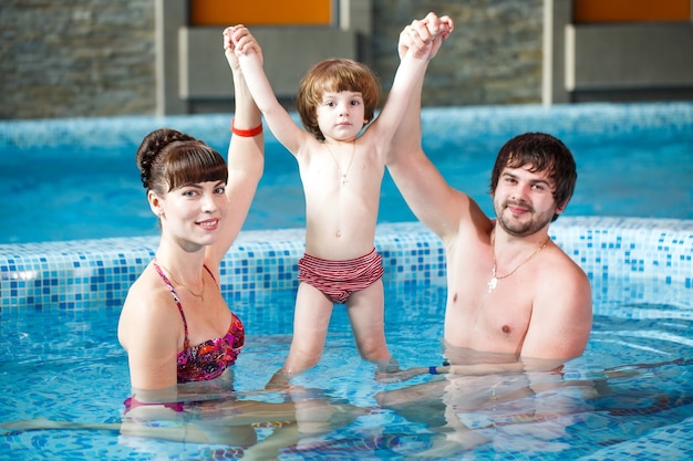 Family swimming in the pool.