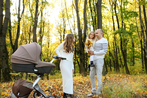 Family take walk in autumn forest