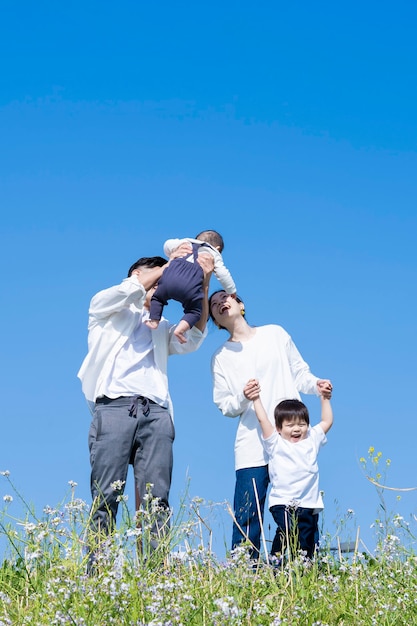 A family taking a walk while having fun on fine day