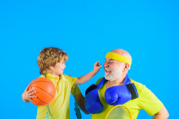 Family time grandfather and kid playing family sport old man with dumbbells portrait of healthy