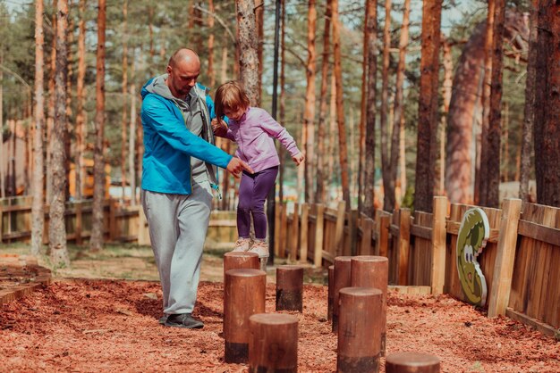 Family time in the park. Father have fun with his daughter in the park, playing fun games and spending time together.