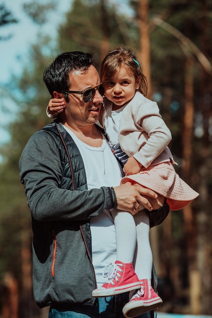 Family time in the park. Father have fun with his daughter in the park, playing fun games and spending time together.