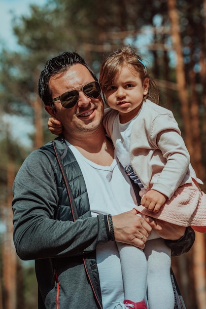 Family time in the park. Father have fun with his daughter in the park, playing fun games and spending time together.