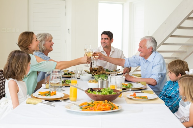 Family toasting while having meal