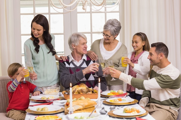 Family toasting with champagne in a christmas dinner