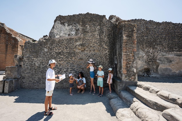 Family tourist visit Pompeii ancient city Italy